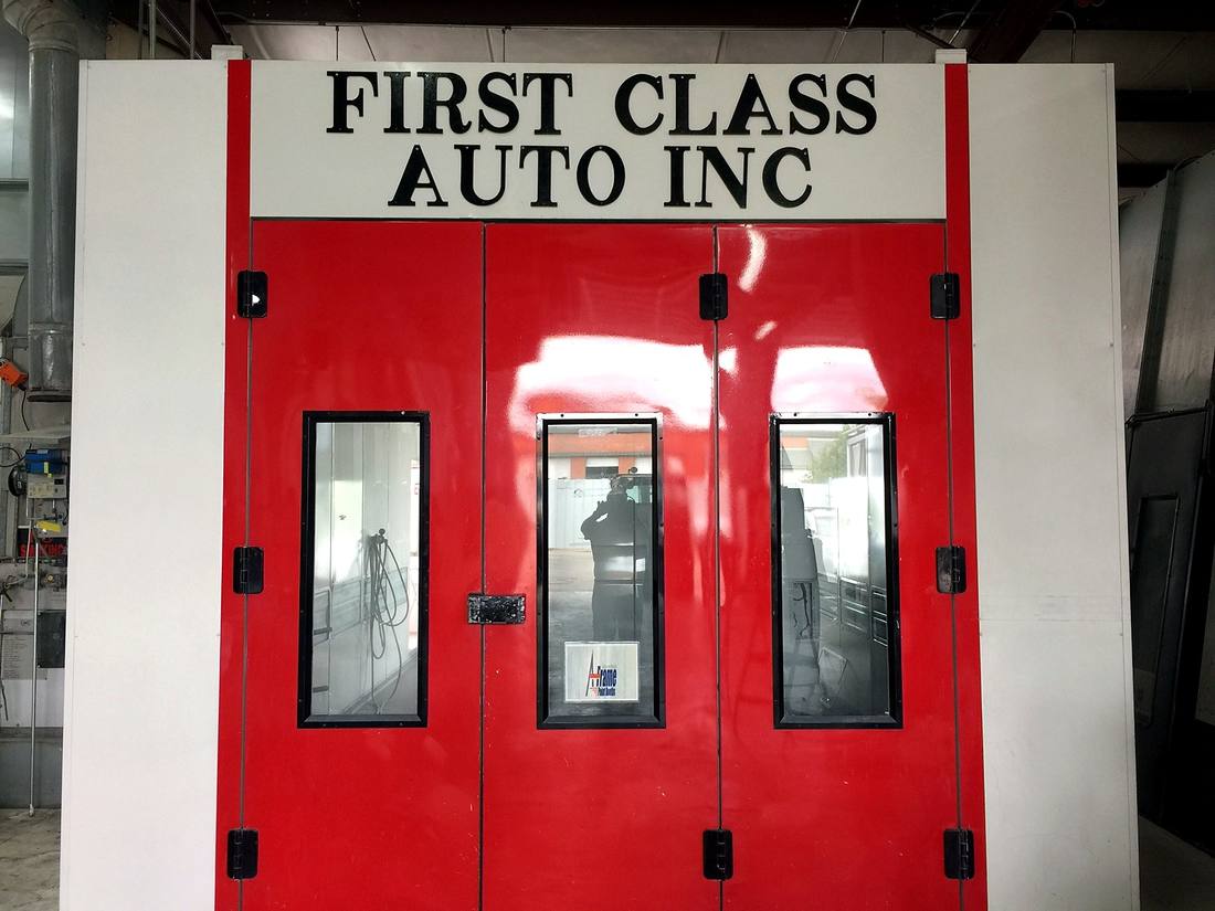 First Class Auto Inc. branded paint booth doors inside the facility