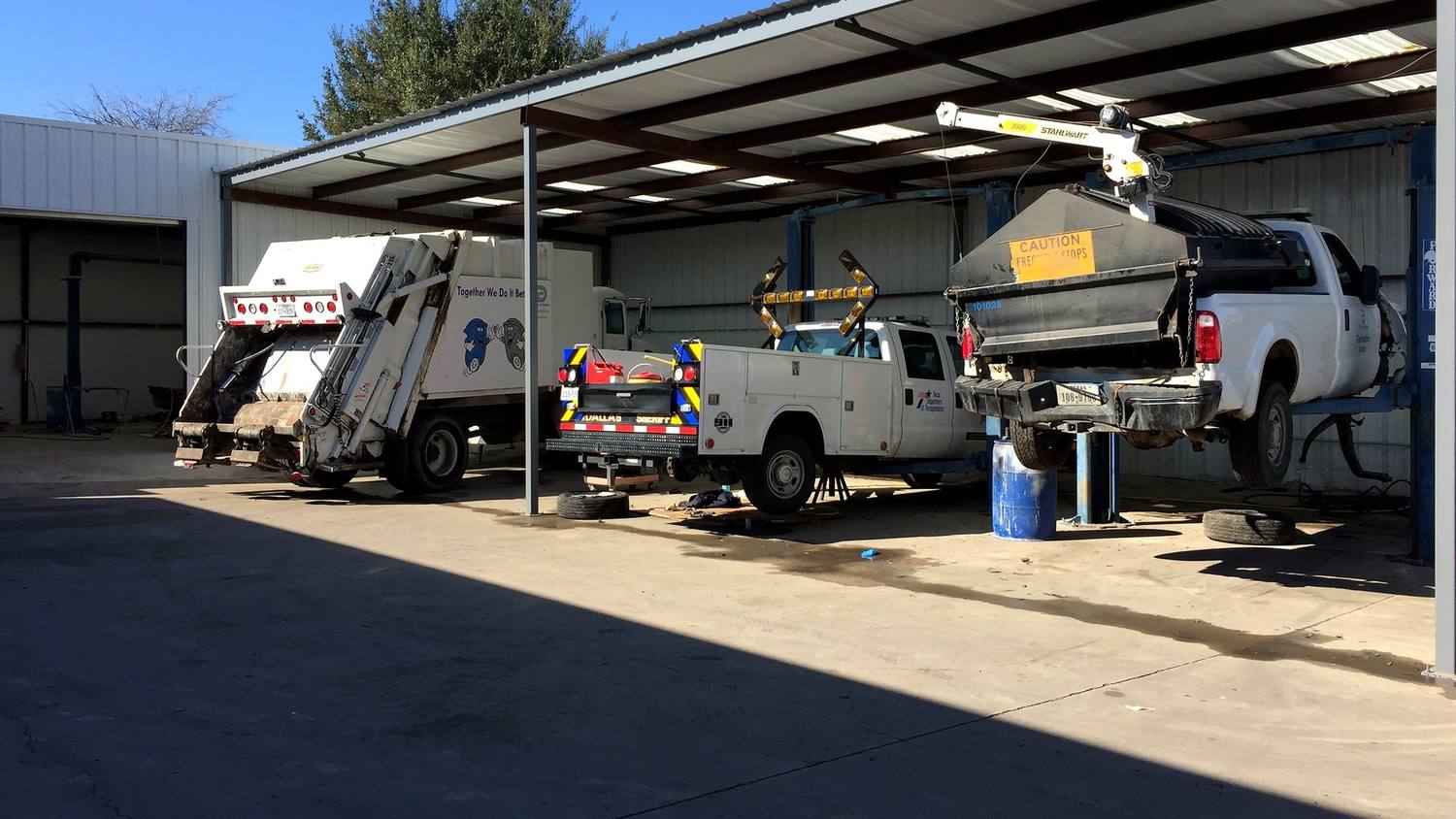 Wide view of a large collision repair facility floor