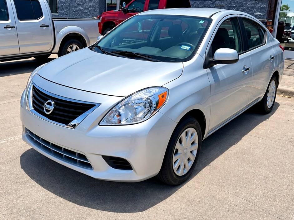 Silver Nissan sedan after completed collision repair, photographed at the First Class Auto facility