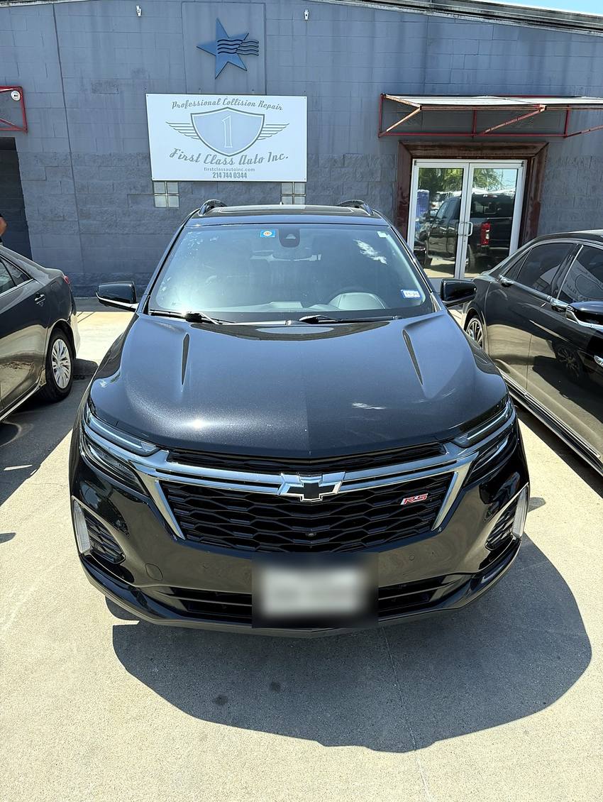 The same Chevrolet Equinox photographed head-on at the First Class Auto facility